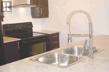 Toronto (Bendale) condo for rent - A kitchen with a sink and a stove.
