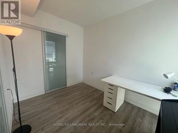 Toronto (Church-Yonge Corridor) condo for rent - A room with a desk and a floor lamp.