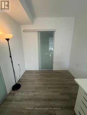 Toronto (Church-Yonge Corridor) condo for rent - A room with a wooden floor and a white wall with a doorway.