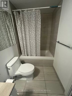 Toronto (Church-Yonge Corridor) condo for rent - A white toilet sits in a bathroom with a shower curtain.