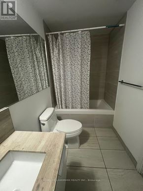 Toronto (Church-Yonge Corridor) condo for rent - A bathroom with a toilet, sink, and shower curtain.