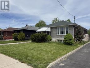 Toronto (Wexford-Maryvale) apartment for rent - A house with a grey roof and a white awning is for sale.