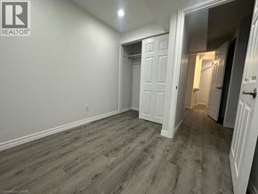Brantford apartment for rent - A room with a wooden floor and white walls.