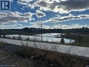 Brantford apartment for rent - A realtor's photo of a landscape with a body of water and houses in the distance.