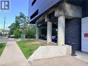 Waterloo condo for rent - A concrete structure with a sign that says REALTOR in the upper left corner.