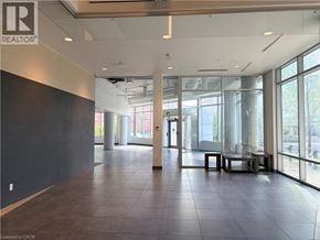 Waterloo condo for rent - A large, empty room with a REALTOR® logo on the wall.