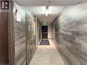 Waterloo condo for rent - A hallway with a stone wall and a door on the left.