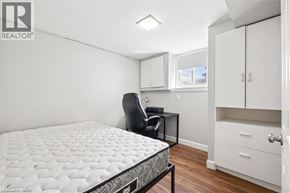 Kitchener apartment for rent - A bedroom with a bed, desk, and chair.