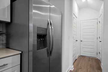 Gallatin apartment for rent - A stainless steel refrigerator in a kitchen with white cabinets.