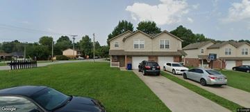 Sellersburg apartment for rent - A black car is parked in front of a house.