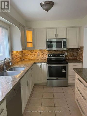 Mississauga (Cooksville) apartment for rent - A kitchen with a stove top oven and a microwave.