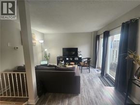 Cambridge townhouse for rent - A living room with a couch, television, and a chair.