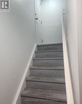 Brampton (Fletcher's Creek South) apartment for rent - A staircase with a sign that says "HOMELIFE MIRACLE REALTY LTD Brokerage".