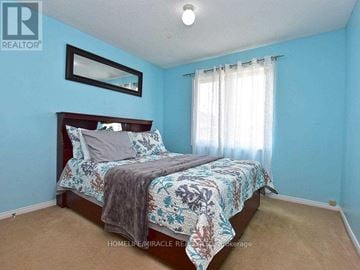 Brampton (Fletcher's Creek South) apartment for rent - A bedroom with a bed and a mirror on the wall.