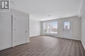 Ottawa townhouse for rent - A room with a white door and a window with a view of a building outside.