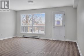 Ottawa townhouse for rent - A room with a large window and a door.
