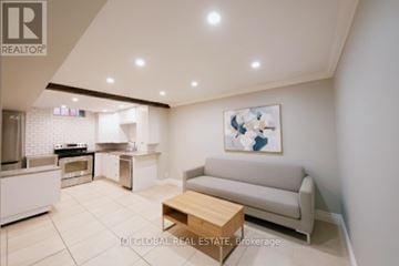 Oakville (Ro River Oaks) apartment for rent - A modern living room with a grey sofa and a wooden coffee table.