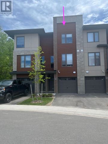 Collingwood townhouse for rent - A black truck is parked in front of a two-story building.