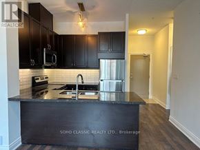 Vaughan (Maple) condo for rent - A kitchen with black cabinets and a black countertop.
