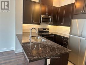 Vaughan (Maple) condo for rent - A kitchen with a granite countertop and stainless steel appliances.
