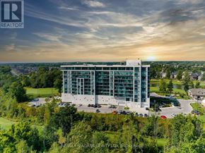 Niagara Falls (Oldfield) condo for rent - A modern building with a glass facade is surrounded by greenery and is the focus of this image.