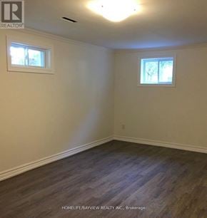 Toronto (Malvern) apartment for rent - A room with wooden flooring and two windows.