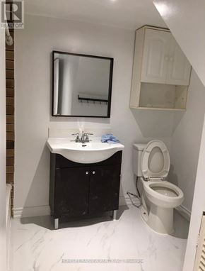 Toronto (Malvern) apartment for rent - A white toilet sits next to a sink in a small bathroom.