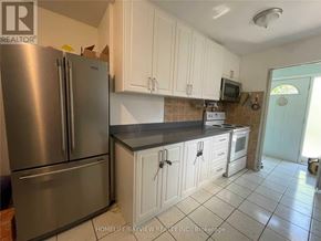 Toronto (Malvern) apartment for rent - A kitchen with a refrigerator, cabinets, and a microwave.