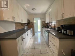 Toronto (Malvern) apartment for rent - A kitchen with white cabinets and a tile floor.