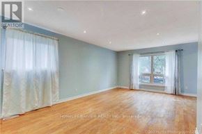 Toronto (Malvern) apartment for rent - A room with wooden floors and a window with curtains.