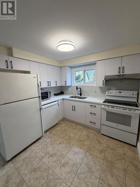 Guelph (Kortright West) apartment for rent - A kitchen with white appliances and cabinets.