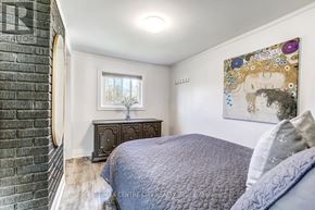Central Elgin (Port Stanley) apartment for rent - A bedroom with a bed, nightstand, and a painting on the wall.