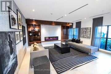 Oakville (Go Glenorchy) condo for rent - A living room with a grey couch and a black coffee table.