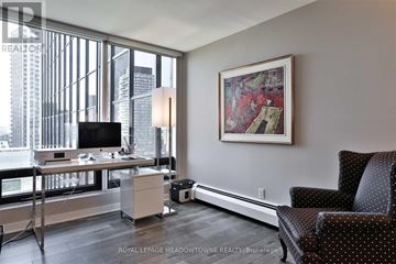 Toronto (Church-Yonge Corridor) condo for rent - A modern living room with a large window, a desk, a chair, and a painting on the wall.