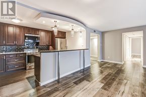 Toronto (Church-Yonge Corridor) condo for rent - A modern kitchen with dark wood cabinets and a white island.