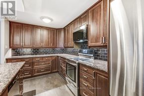 Toronto (Church-Yonge Corridor) condo for rent - A kitchen with brown cabinets and a granite countertop.