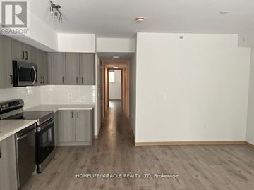 Toronto (Tam O'shanter-Sullivan) townhouse for rent - A kitchen with a stove top oven and cabinets.