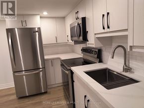 Markham (Grandview) apartment for rent - A modern kitchen with a stainless steel refrigerator and black countertops.