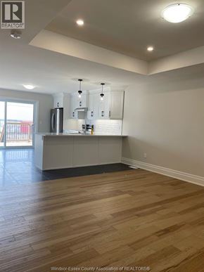 Essex townhouse for rent - A kitchen with wooden floors and white walls.