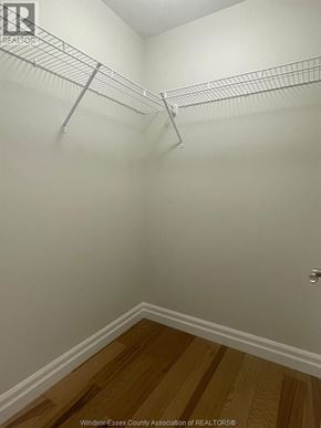 Essex townhouse for rent - A white wall with a metal rack and a wooden floor.