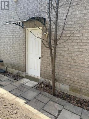 Vaughan (East Woodbridge) apartment for rent - A white door is on the left side of a brick wall.