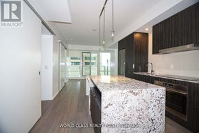 Toronto (Church-Yonge Corridor) condo for rent - A modern kitchen with a marble island and dark wood cabinets.