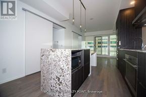Toronto (Church-Yonge Corridor) condo for rent - A modern kitchen with a granite island in the middle.