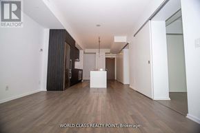 Toronto (Church-Yonge Corridor) condo for rent - A spacious room with wooden flooring and white walls, with a white table in the middle.