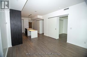 Toronto (Church-Yonge Corridor) condo for rent - A real estate listing image of a spacious room with wood flooring and white walls.