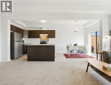 Fort Erie townhouse for rent - A spacious kitchen with a dining table set for four.