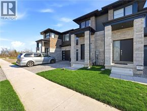 Fort Erie townhouse for rent - A modern house with a grey car parked in front.