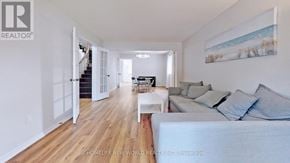 Mississauga (Erin Mills) apartment for rent - A living room with a couch, a coffee table, and a painting on the wall.