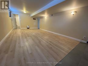 Cornwall apartment for rent - A spacious room with light wood flooring and white walls.