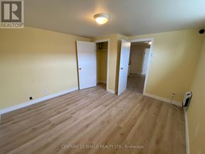 Cornwall apartment for rent - A room with wooden flooring and two doors.